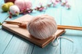 Ball of knitting yarn with needles and book on wooden table Royalty Free Stock Photo
