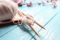 Ball of knitting yarn with needles and book on wooden table Royalty Free Stock Photo