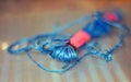 A ball of muline thread lying on a plastic surface with a blurred background