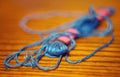 A ball of muline thread lying on a wooden table with a blurred background