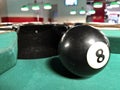 8 ball next to a hole Royalty Free Stock Photo