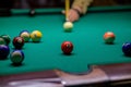 The ball with number 3 at which the cue ball is aiming. a man plays billiards in a bar. snooker Royalty Free Stock Photo