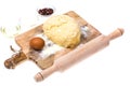 Ball of pizza dough on wooden kitchen cutting board with dusting of flour Royalty Free Stock Photo