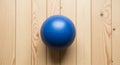 Ball placed on a light wood surface with distinct vertical grain Royalty Free Stock Photo