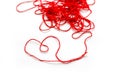 A ball of red wool yarn. Thread laid out the shape of a heart. C Royalty Free Stock Photo