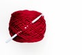 A ball of red yarn and crochet hooks on a light background. Royalty Free Stock Photo