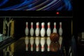 Ball rolling on the right side a bowling alley lane with pins