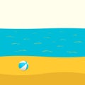 ball on a sandy beach, blue sea with ripples, white sky