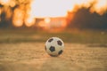 A ball for street soccer football under the sunset ray light. Film picture style.