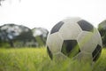 A ball for street soccer football under the sunset ray light in grass field area with abstract lights blurred bokeh copy space Royalty Free Stock Photo