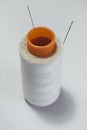Ball of white thread with a needle on a white background Royalty Free Stock Photo