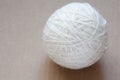 Ball of white wool yarn on cardboard background Royalty Free Stock Photo