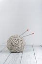 Ball of wool with spokes for handmade knitting on wooden table. Knitting wool and knitting needles. Royalty Free Stock Photo