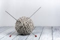 Ball of wool with spokes for handmade knitting on wooden table. Knitting wool and knitting needles. Royalty Free Stock Photo