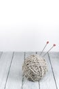 Ball of wool with spokes for handmade knitting on wooden table. Knitting wool and knitting needles. Royalty Free Stock Photo