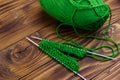 Ball of yarn and knitting needles with knitting on wooden table Royalty Free Stock Photo