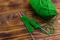 Ball of yarn and knitting needles with knitting on wooden table Royalty Free Stock Photo