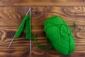 Ball of yarn and knitting needles with knitting on wooden table. Top view Royalty Free Stock Photo