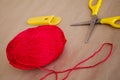 Ball of yarn. A ball of red thread. A ball of thread and scissors. Edge cotton threads Royalty Free Stock Photo