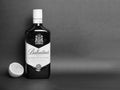 Ballantyne`s whiskey bottle and half lemon monochrome photo
