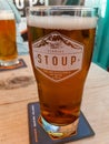 Vertical closeup view of a refreshing pint glass of beer at the popular Stoup Brewing Ballard