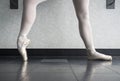 Ballerina in ballet class warming up her pointe shoes, ballet slippers at the barre Royalty Free Stock Photo