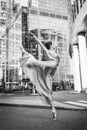 Ballerina, ballet dancer on modern city background. Attitude position. Royalty Free Stock Photo