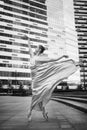 Ballerina, ballet dancer on modern city background. Grainy black and white photo