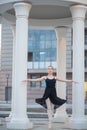 Ballerina in a black dress is a beautiful pose. A beautiful young woman in a black bodysuit is dancing in an elegant Royalty Free Stock Photo