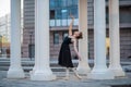 Ballerina in a black dress is a beautiful pose. A beautiful young woman in a black bodysuit is dancing in an elegant classical Royalty Free Stock Photo