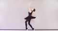 Ballerina in black swan dress. Young ballet dancer practicing before performance in black tutu, classical dance studio, copy space Royalty Free Stock Photo