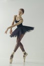 ballerina in a black tutu shows elements of ballet dance in motion