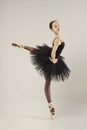 ballerina in a black tutu shows elements of ballet dance in motion