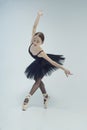 ballerina in a black tutu shows elements of ballet dance in motion