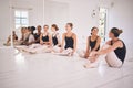 Ballerina, class and ballet dancers practice, training and exercise in a hall as a young healthy and energetic group