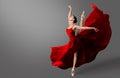 Ballerina Dance. Ballet Dancer in Red Dress jumping Spit. Woman in Ballerina Shoes dancing in Evening Silk Gown flying on Wind Royalty Free Stock Photo