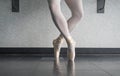Ballerina dancer in the ballet studio en pointe in releve fourth position Royalty Free Stock Photo