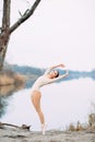 Ballerina dances at the lake shore