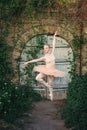 Ballerina dancing outdoors classic ballet poses in urban background Royalty Free Stock Photo