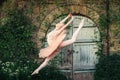 Ballerina dancing outdoors classic ballet poses in urban background Royalty Free Stock Photo