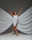 Ballerina Dancing with Silk Fabric, Modern Ballet Dancer in Fluttering Waving Cloth, Pointe Shoes, Gray Background Royalty Free Stock Photo