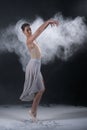 Ballerina dancing in studio with white flour Royalty Free Stock Photo