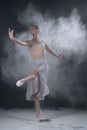 Ballerina dancing in studio with white flour Royalty Free Stock Photo