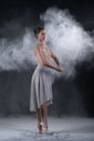 Ballerina dancing in studio with white flour Royalty Free Stock Photo