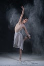 Ballerina dancing in studio with white flour Royalty Free Stock Photo