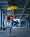 Ballerina dancing with umbrella. Street performance.