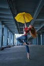 Ballerina dancing with umbrella. Street performance.