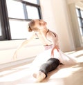 Ballerina Doing Splits in Sunny Studio Royalty Free Stock Photo