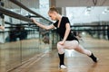 Ballerina doing stretching exercises Royalty Free Stock Photo