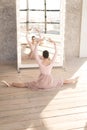 Ballerina in dress sitting twine in front of mirror
